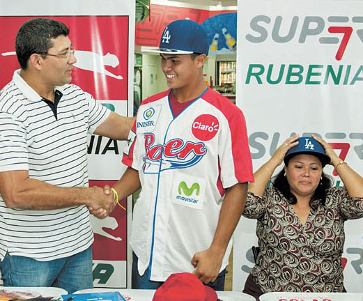 International scout Luis Molina welcomes 17-year-old shortstop Mike Loaisiga to the Dodgers family as his mom look on. (Photo credit - Jorge Torres)