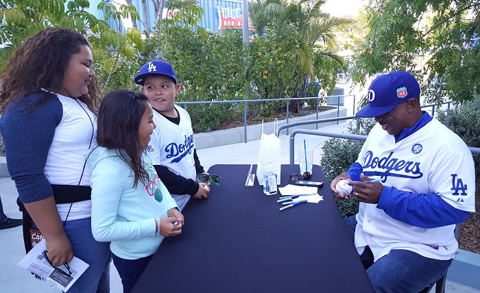 Chris's father Dennis is very active with the Dodgers alumni. He is seen here signing autographs for fans prior to Thusday night's freeway Series open against the Angels at Dodger Stadium. (Photo credit - Ron Cervenka)